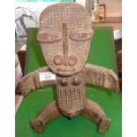 Tribal Art: African carved wood fertility figure of a seated woman with outstretched arms