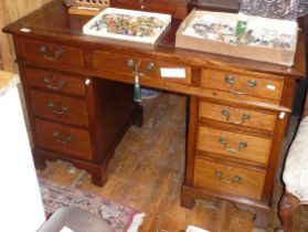19th c. cross banded oak kneehole pedestal desk of 9 drawers with brass swan neck handles and having