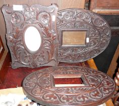 Three Arts & Crafts carved oak frames, one on easel stand