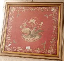 Victorian embroidery of birds on a red silk background