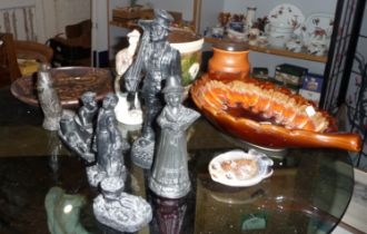 Group of cast figures made with coal dust, a Studio pottery slipware plate decorated with