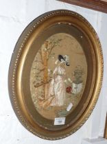 19th c. silk embroidered picture of a lady watering a garden, in oval frame