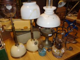 Two antique Tilley table lamps (shades A/F), three various oil lamps and a wrought iron stand