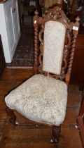 Victorian walnut nursing chair having barley twist uprights and carvings to back, standing on