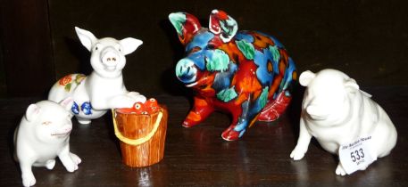 Two Belleek china pigs and two other pigs