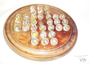 Old marbles and a solitaire board