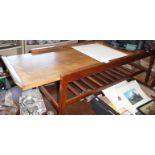 A mid-century teak adjustable coffee table with formica centre section