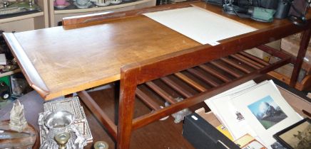 A mid-century teak adjustable coffee table with formica centre section