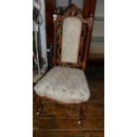 Victorian walnut nursing chair having barley twist uprights and carvings to back, standing on