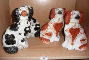 Two pairs of Staffordshire pottery dogs