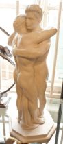 A sculpture of two men embracing, 16" tall