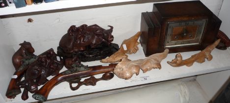 Two replica flintlock pistols, a pair of carved water buffaloes, other carvings and a mantle clock