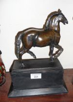 A bronze figure of a walking horse, after the antique, 20cm high on wooden plinth, overall height