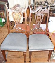 Pair of Art Nouveau mahogany chairs with shaped backs and upholstered seats