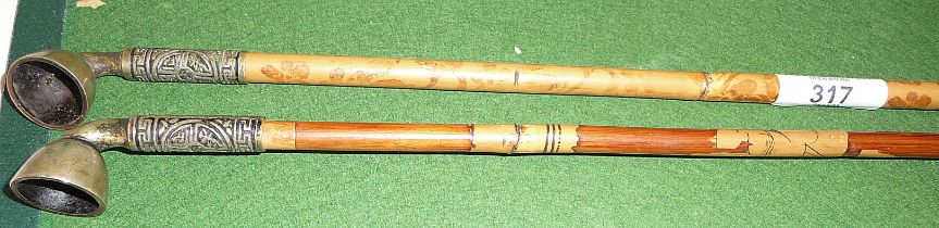 Two Chinese long stemmed decorated bamboo opium pipes