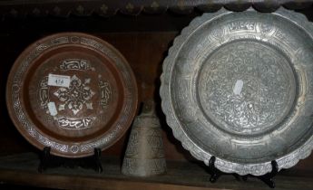 Islamic copper plate with silver inlaid decoration 24cm diameter, a pewter similar, signed, 29cm