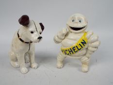 A cast iron money bank in the form of Nipper the HMV dog and a Bibendum (Michelin Man) figure,