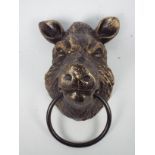 A bronzed, cast iron, wall mountable boar's head, approximately 22 cm,