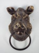 A bronzed, cast iron, wall mountable boar's head, approximately 22 cm,