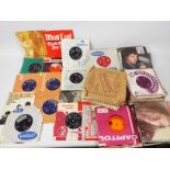 A collection of 7" vinyl records to include The Rolling Stones, The Animals, Meatloaf, Johnny Cash,