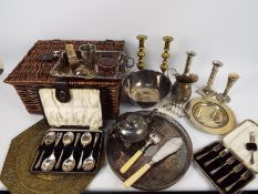 A basket containing a quantity of plated ware and a small quantity of brass ware,