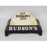 A cast iron water bowl marked Hudson's Soap, approximately 20 cm x 38 cm x 19 cm,