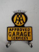 A wall mountable key hook marked AA Approved Garage Services, approximately 21 cm (h),