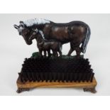 A cast iron and wood, doorstop and boot brush with horse and foal decoration, 23 cm (h),