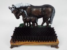 A cast iron and wood, doorstop and boot brush with horse and foal decoration, 23 cm (h),