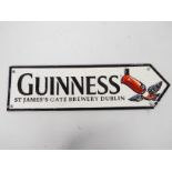 A cast iron directional sign, marked Guinness with toucan decoration, 11 cm x 38 cm,