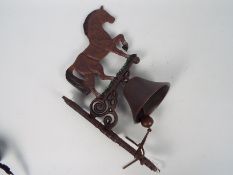 A wall mountable, cast iron bell with horse surmount, approximately 42 cm (h),