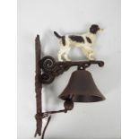 A cast iron, wall mountable, bell with springer spaniel surmount, approximately 36 cm (h),