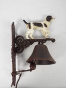 A cast iron, wall mountable, bell with springer spaniel surmount, approximately 36 cm (h),