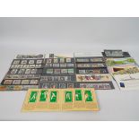 Philately - A small quantity of Royal Mail Mint Stamp presentation packs and a tennis players