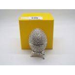 A crystal encrusted egg form trinket box