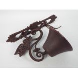 A cast iron, wall mountable, bell with butterfly decoration, approximately 34 cm (h),