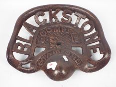 A cast iron tractor seat marked Blackstone & Company Ltd, approximately 39 cm (l),