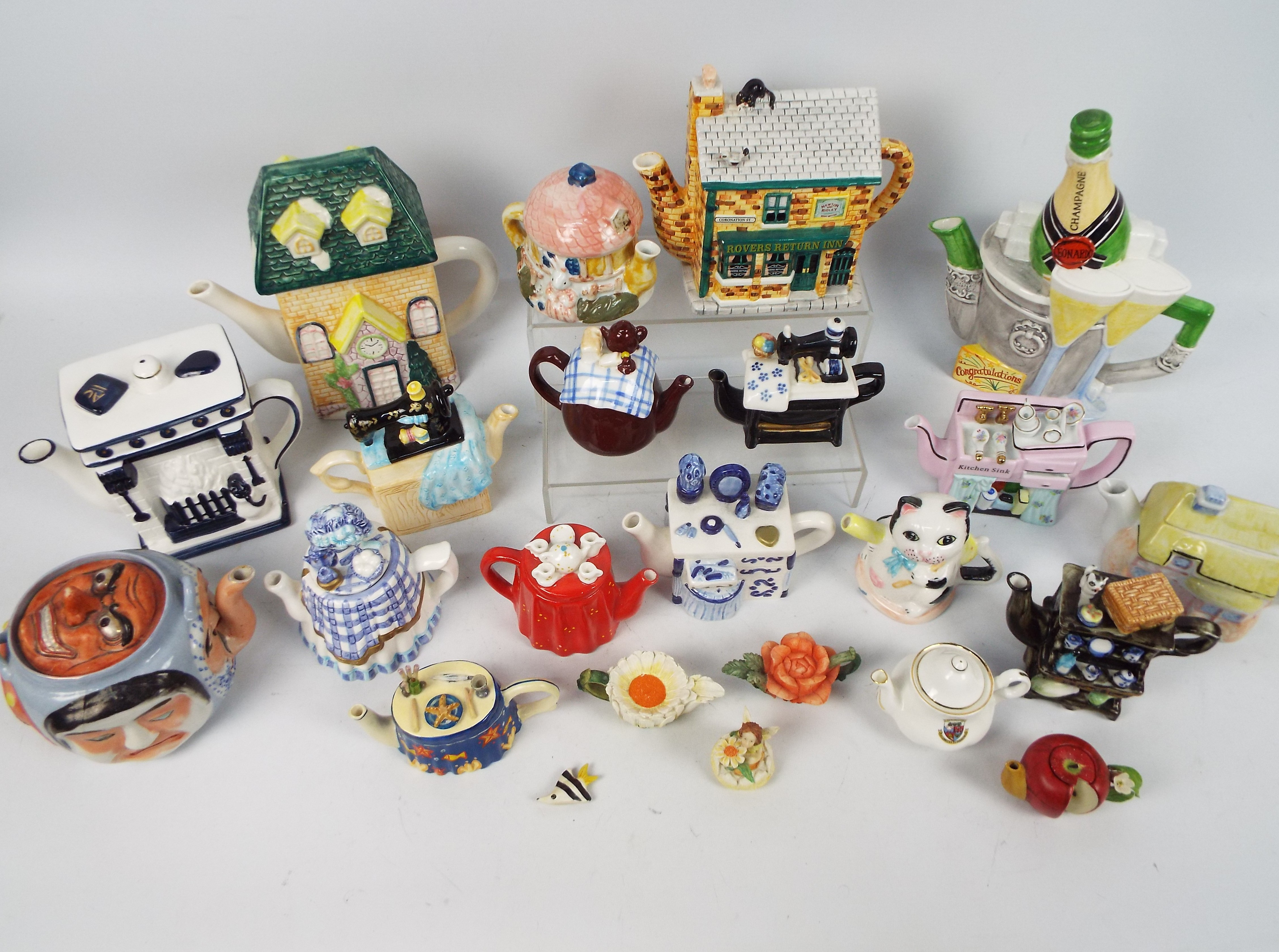 A collection of various novelty teapots.