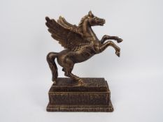A bronzed cast iron model depicting Pegasus, approximately 34 cm (h),