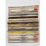 A collection of 12" vinyl records to include The Beatles, Johnny Cash, The Kinks,
