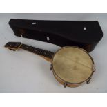 A vintage Savana banjolele contained in case, appears in good condition, needs restringing,