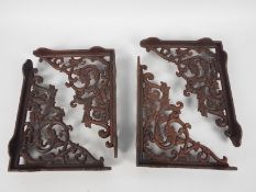 Four cast iron wall brackets, approximately 22 cm x 28 cm,