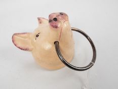 A cast iron, wall mountable model of a pig's head, approximately 20 cm,