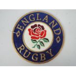 A cast iron wall plaque marked England Rugby, 23 cm (d),