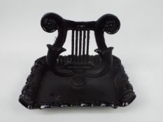 A cast iron boot scraper in the form of a lyre, approximately 24 cm (h),