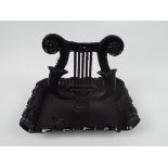 A cast iron boot scraper in the form of a lyre, approximately 24 cm (h),
