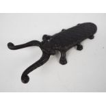 A cast iron boot jack in the form of a beetle, approximately 30 cm (l),