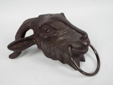 A cast iron, wall mountable, rams head, approximately 23 cm,