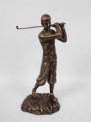 A bronzed, cast iron figure depicting a golfer in mid-swing, approximately 29 cm (h),