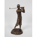 A bronzed, cast iron figure depicting a golfer in mid-swing, approximately 29 cm (h),